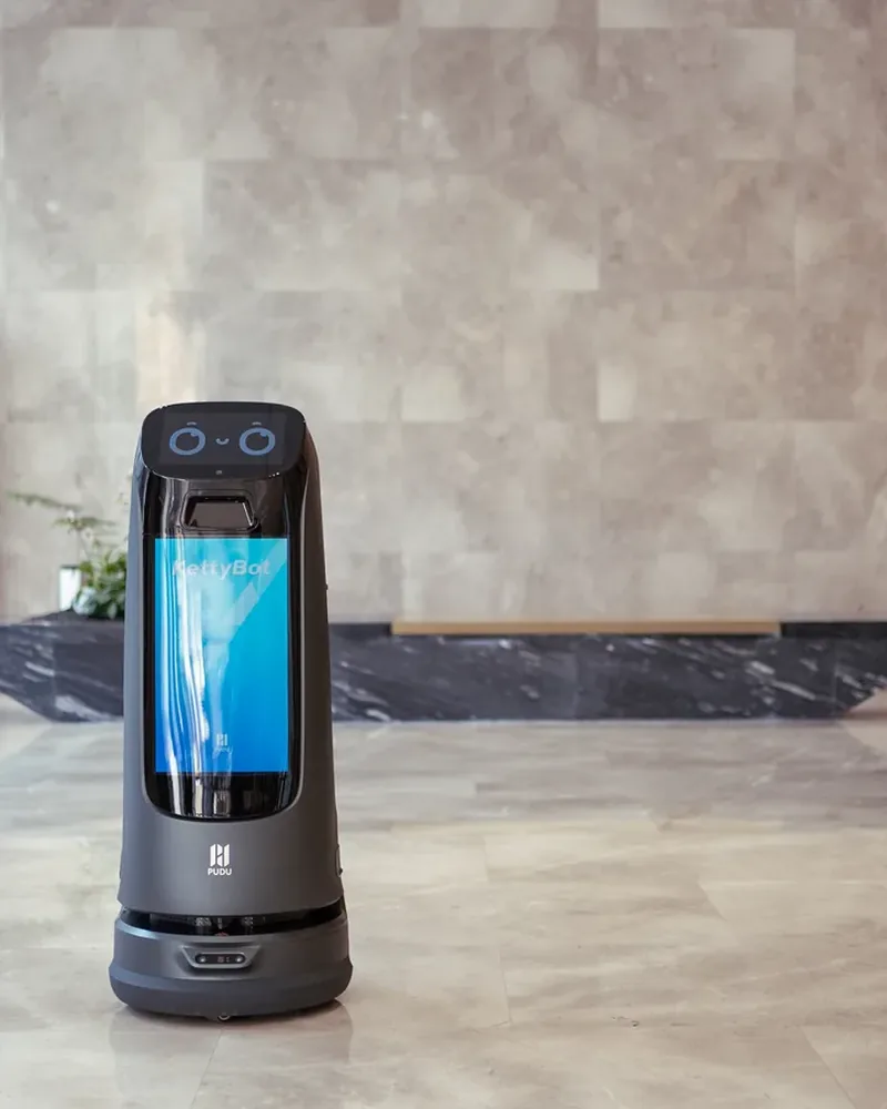 PUDU KettyBot Pro in a marble hotel lobby