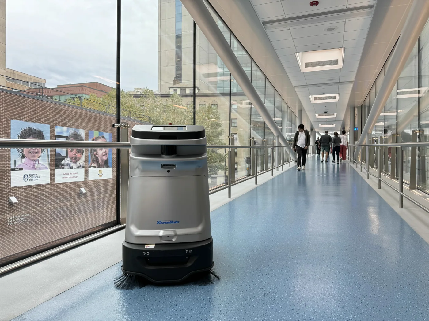 An autonomous SP50 spot cleaner on a busy retail floor